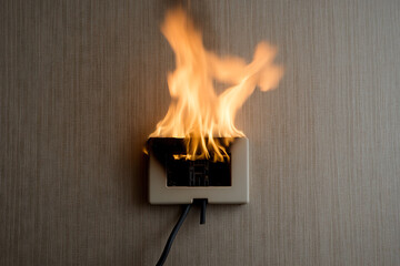 Electrical Outlet Fire: A hazardous situation with flames erupting from an outlet on a textured wall. Highlight electrical safety and fire prevention.