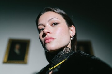 Elegant Woman Posing with Dramatic Lighting and Vintage Background