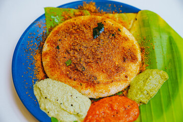 Traditional South Indian breakfast dish, soft idlies served with coconut chutney and sambar. Represents Indian cuisine, comfort food, and cultural culinary heritage