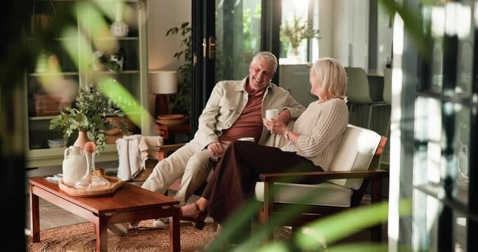 Laugh, drinking coffee and senior couple in home, talking or bonding in morning together. Elderly man, woman and tea in living room, funny story or communication with partner for joke in retirement