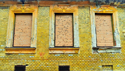 Old 19 century building with broken shutters.