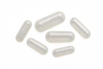 Empty clear capsule shells scattered, preparing custom dietary supplements, vitamins, or medicine dosage