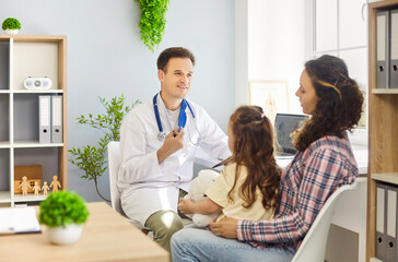 Doctor consults mother and daughter at clinic. The pediatrician outlines care options, building trust with child and family in a healthcare office. Concept supportive family medical consultation.