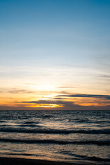 Vertical sunset over calm Caribbean sea with golden light near Coveñas, Colombian coast