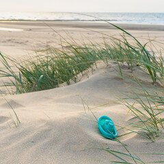 Footpath through dunes with footsteps, tracks in the sand between sedge bushes, footprints on the way, blowing grass in the wind, nobody, a lonely path by the North Sea, solitude