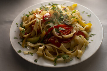 Italian pasta in a white plate close up. Traditional Mediterranean cuisine and homemade culinary recipes.