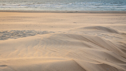 Wind makes structures in the sand at the North Sea, natural art on the sandy beach, a storm over the beach forms sand, a beautiful pattern