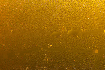 Extreme Close-up of Cold Golden Beer Foam and Condensation