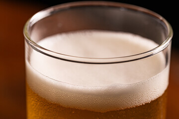 Extreme Close-up of Cold Golden Beer Foam and Condensation