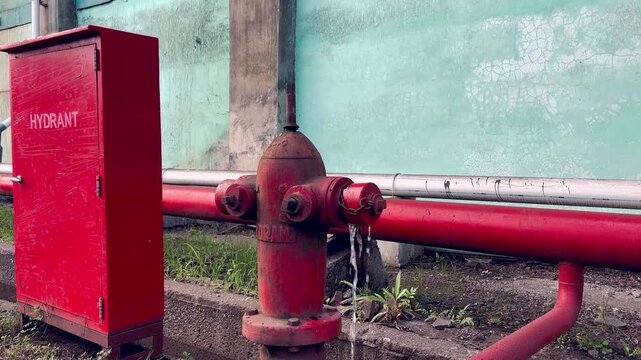 Fire hydrant with water flowing outdoors, ready for emergency situations, safety and protection