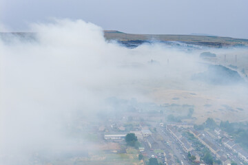 Thick smoke from a wildfire in the Brecon Beacons drifting over nearby homes