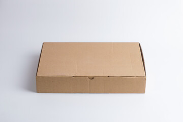 Front view flat cardboard box mockup on white. Minimal kraft paper packaging for e-commerce shipping, food delivery, eco-friendly, and recyclable product design.

