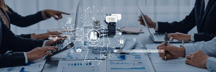 A modern office scene showcasing team members collaborating with laptops, discussing projects, and utilizing technology for effective communication and data analysis. Trope