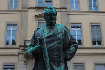 Close-up of an iron statue in front of an old building in Heidelberg, Germany, depicting Robert Wilhelm Bunsen