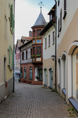 narrow street in old town in germany with old stone and half-timbered fachwerk buildings