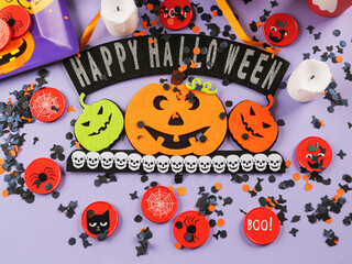 Happy halloween greetings decor with pumpkins on purple orange background