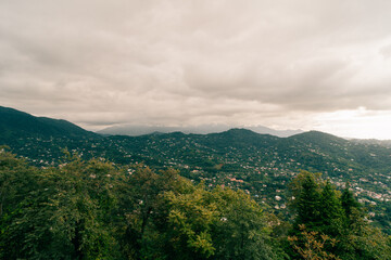 travel to Georgia - green trees and view of Batumi city with suburb from Sameba hill on autumn day