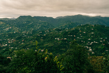 travel to Georgia - green trees and view of Batumi city with suburb from Sameba hill on autumn day