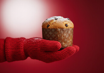 Festive panettone held in cozy red mittens, a symbol of warm holiday traditions and delicious Italian baking perfect for Christmas and New Year celebrations