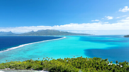 Luxury resort photo of Bora Bora tropical paradise islands with palm trees. Aerial 
perspective photography, coral reef, azure ocean, 
sky with clouds on horizon. French Polynesia.
Pacific Ocean.