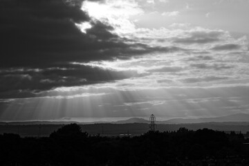 Storm clouds and sun rays over the city