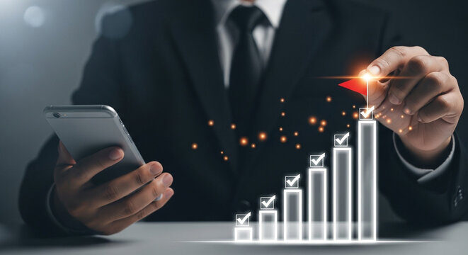 Professional businessman using smartphone to achieve success goals with glowing graph and red flag milestone