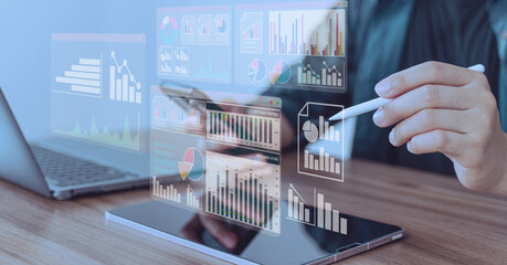 Person using stylus and laptop with multiple floating financial dashboards, symbolizing data analytics, investment, and fintech tools.