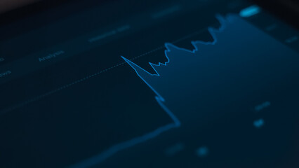 Stock market screen showing price drop graph.