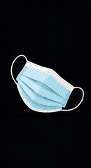 Light Blue Surgical Mask on Black Background for Protection.