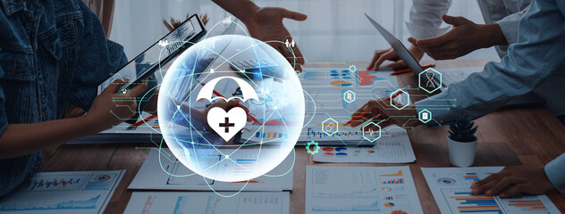 Business professionals engage in a collaborative health care data analysis session, utilizing tablets and laptops, surrounded by charts and digital health icons. Trope