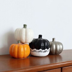 Decorative Pumpkins in Warm Tones Arranged on Wooden Surface