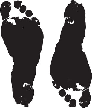 Black silhouette of two bare human footprints on a white background