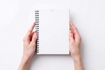 Hands Holding Spiral Notebook on White Background