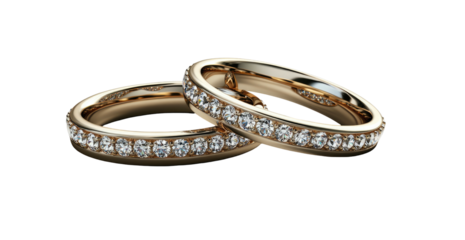 Two golden wedding bands adorned with glittering gemstones, resting