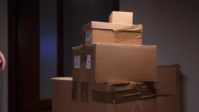 Man stacking cardboard boxes during office relocation