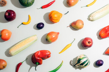Assorted fresh vegetables and fruits on light background, colorful flat lay composition. Healthy organic food concept. Top view