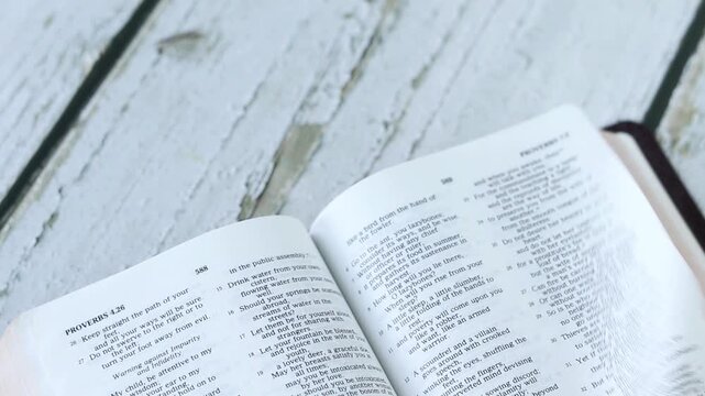 Turning pages of Christian holy bible book. Studying and reading Scriptures, biblical concept.