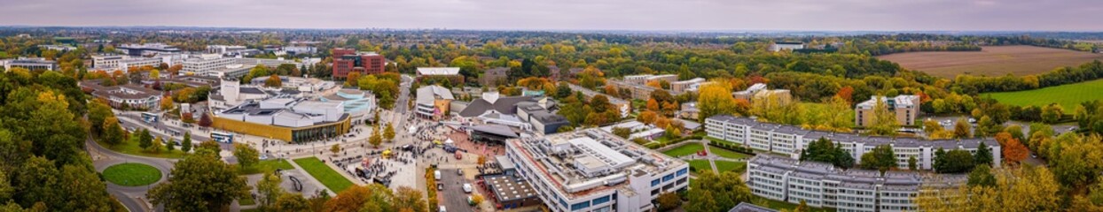 Aerial view of the University of Warwick campus surrounded by trees in autumn colors