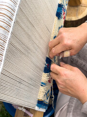 Carpet weaving using traditional techniques on a loom. , close-up of weaving and handmade carpet production.