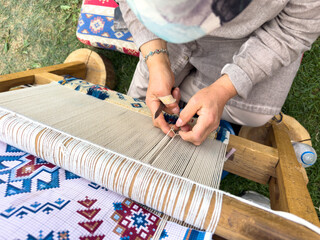 Carpet weaving using traditional techniques on a loom. , close-up of weaving and handmade carpet production.