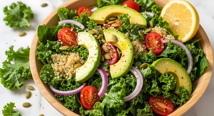 Close up of a kale salad with avocado tomatoes red onion quinoa and lemon in a wooden bowl view