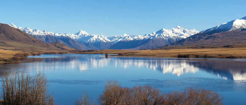 Lake Clearwater surrounded by snow capped mountain peaks of Southern Alps