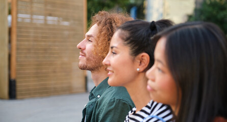 Fototapeta premium Three young professionals looking up at something with hope and expectation