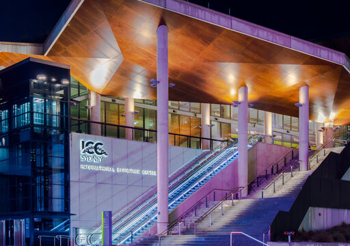 Sydney, Australia, July 23, 2023. Front view of Sydney International Convention Centre (ICC) illuminated with colourful lights in the night.