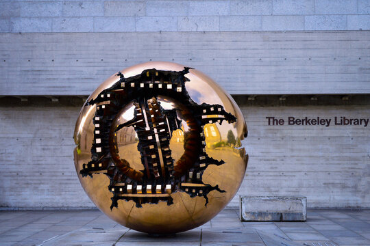 Dublin, Ireland, July, 2016. The Bronze Sculpture of 'Pomodoro Sphere' aka &lsquo;Sfera con Sfera", "Sphere With Sphere" in the Berkeley Library forecourt, Trinity College Dublin, Ireland.