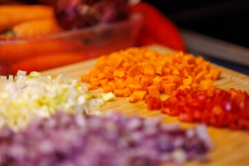 Freshly chopped vegetables on wooden cutting board ready for delicious cooking recipes