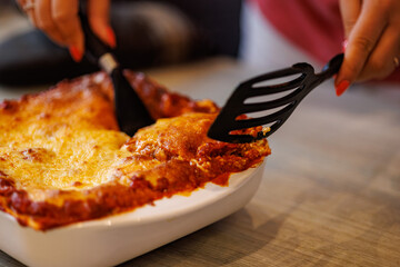 Delicious homemade lasagna being served, ready for dinner and family time together
