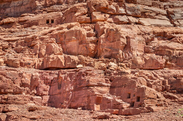 Fototapeta premium View of rock mountains with carved tombs at Dadan, the UNESCO site at Saudi Arabia Alula in a sunny day. 