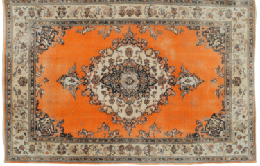Ornate rug with central floral medallion in warm orange and cream tones
