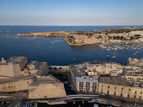 Malta Valletta city skyline panorama with historic Fort St Elmo and Grand Harbour aerial drone view.

